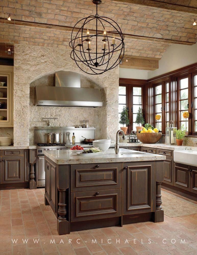 luxury rustic kitchen with square island and ornate chandelier