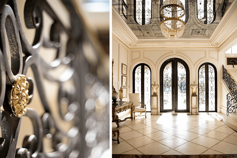 Luxury hotel lobby with 3 glass doors and a chandelier.