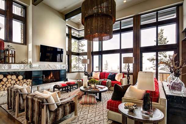 Rustic designed living room with a fireplace and chandelier.