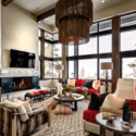 Rustic designed living room with a fireplace and chandelier.