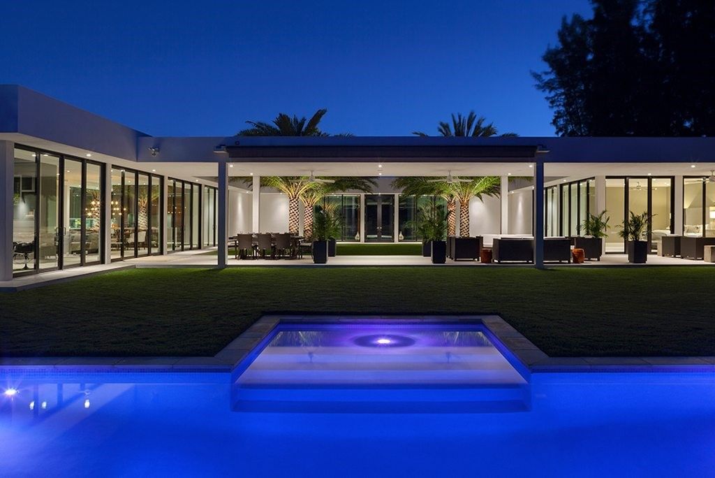 Mid-century modern pool in front of a house.