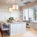 Brightly lit country-style kitchen with light fixtures above an island.
