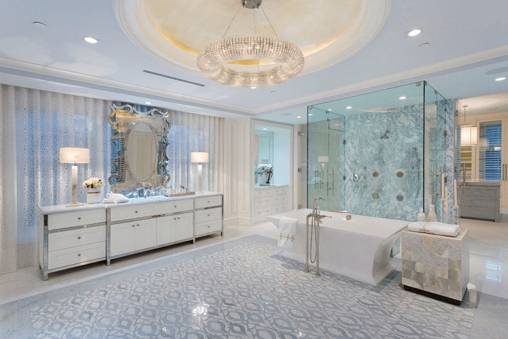 Our Lakefront Palm Beach home's luxury bathroom, with a marble shower, crystal chandelier, and one-of-a-kind tile floor.
