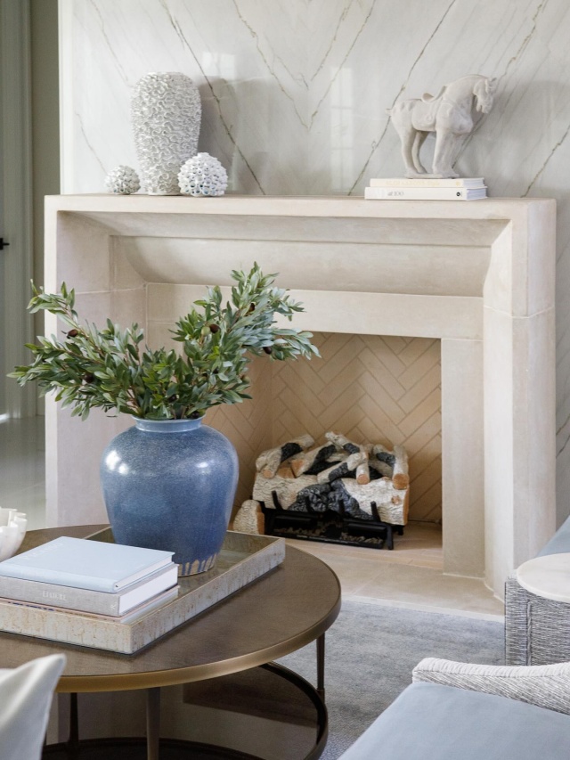 This fireplace anchors the room with organic texture and architectural grace #plaster #limestone #venetianplaster #limestonefireplace #plasterfireplace #palmbeach #interiordesign