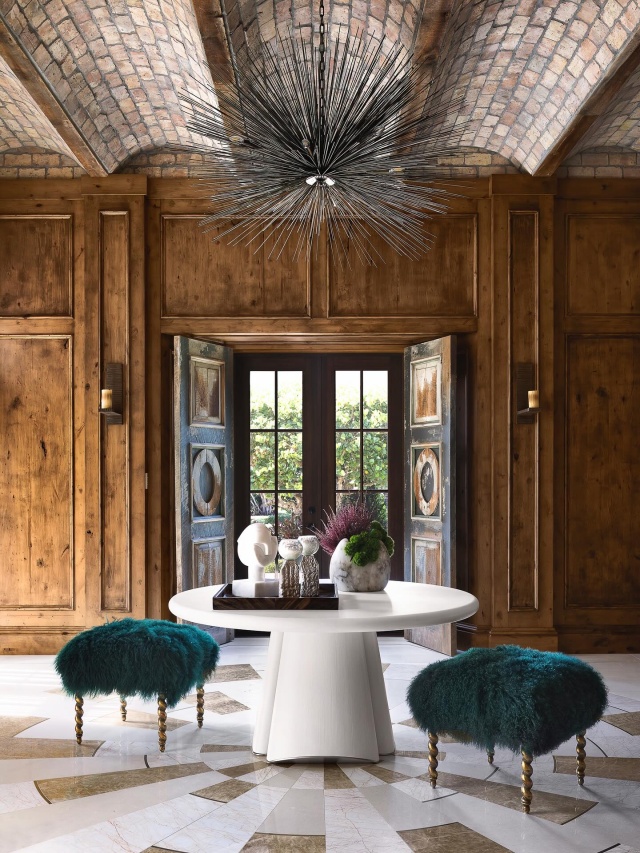 “THE ARCHITECTURE WAS TOO SPECIAL TO IGNORE.” —LINDA HARTMANN
A former study became the formal entry, where a custom inlaid floor uses limestone, two types of onyx and brass insets. Ebanista’s Genevie benches, wearing emerald Mongolian sheepskin, pull up to a round table from Randolph & Hein, and a Gee Gee Collins painting peeks above the mantle. @modernluxury @jessglynnphoto @jessebratter @rwbdesignbuildlive