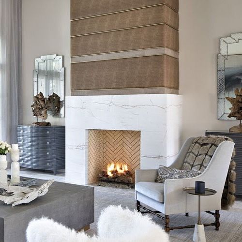 Featured in @marthastewart ✨ Brick, stone, and wood might be typical fireplace mantel materials, but thinking outside the box can lead to an incredible renovation.

The upper part of this fireplace surround uses a mixed-media approach, with materials that nod to a hunting lodge within a modern style. “The fireplace is upholstered in leather and hair-on-hide in a modern, striped detail,” says Mark Tremblay, President of Marc-Michaels Interior Design. #featured #marthastewart #fireplace #interiordesign #fireplacedesign