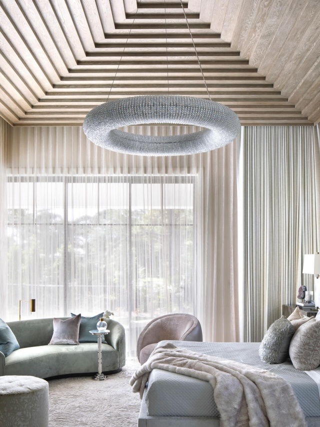 The primary suite evokes quiet luxury. Here, ceilings pyramid upward to create a feeling of infinite expansion, softened by pale greens, blushes and nude tones. Wood details and tactile fabrics add warmth, while hair-on-hide accents and romantic textures underscore a philosophy that bedrooms should be the softest, most intimate spaces in a home. It’s a retreat designed for curling up, cocooned in comfort. Via @luxemagazine Step Inside #luxemagazine #jupiterflorida #luxuryhomes #interiordesign #luxurydesign