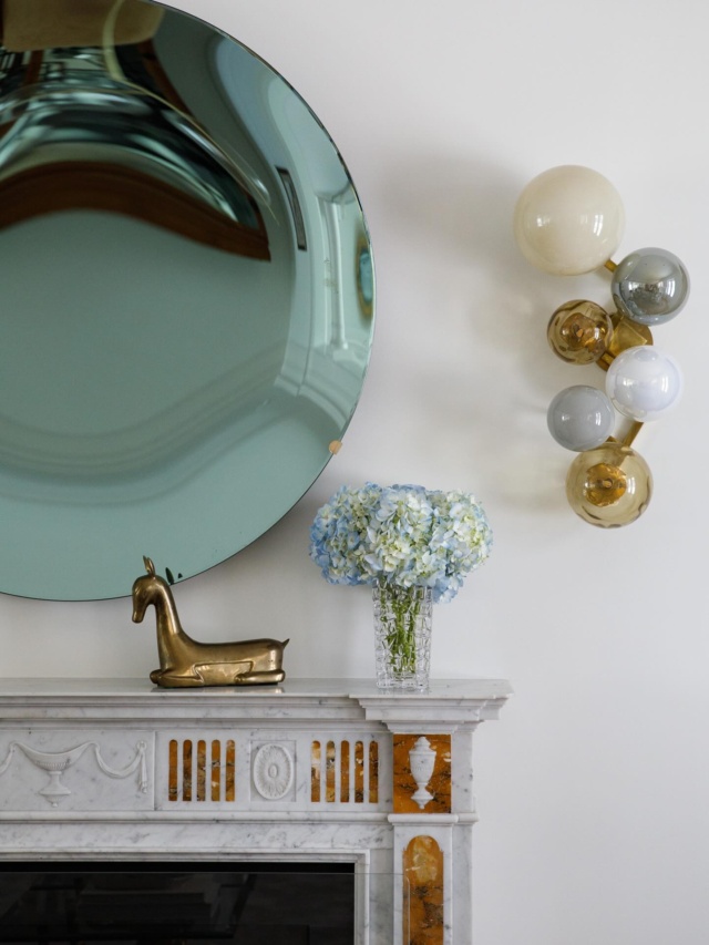 The homeowners original artworks are juxtaposed with a playful mirror. A pair of vintage Willy Daro coffee tables serve a pair of curved sofas. The goat wearing pajamas is by Tammy Lynne Penn 😊🐐 #tradhome #antiques #palmbeach #interiordesign #traddesign