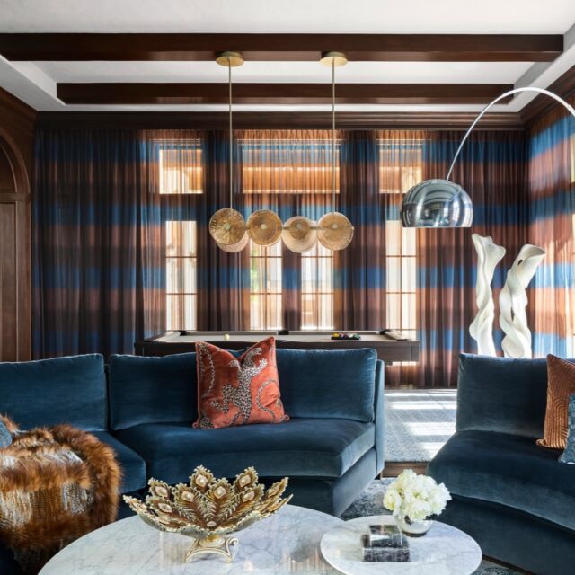 Deep blues, mixed metals, and a little drama with every layer in this moody, timeless living room.
